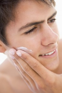 Man putting cream on his face