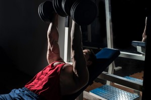 Man exercising using heavy dumbells