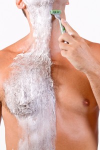 Man shaving his hairy chest