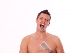 Man removing hair on his chest